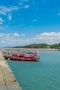 Row of fishing boats docked at concrete pier at Namhang port Royalty Free Stock Photo