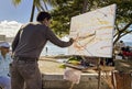 Honolulu, Hawaii - Nov 6, 2021-Man demonstrates painting on a beach en plein air