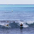 Honolulu, Hawaii - Nov 6, 2021-Young boys play on their boogey boards in the surf Royalty Free Stock Photo