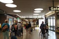 Passengers head to the baggage claim section from a newly arrived plane at the airport