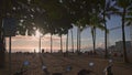 Honolulu, Hawaii, USA - March 17, 2021: Tourists enjoy the warm sun on a tropical beach. Amazing sunset at Waikiki beach Royalty Free Stock Photo