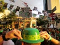 Large crowd of people gather in street in Chinatown during St. Patrick's Day Block Party