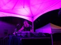 DJ Nick spins on stage in elf outfit in purple lighting at Hallo