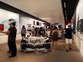 People look at Cars inside Tesla Store