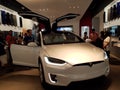 People look at model x Car inside Tesla Store