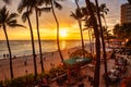 Sunset over waikiki beach on hawaii with palm trees Royalty Free Stock Photo