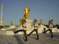 Soldiers with rifles by gold painted statue in Ashgabat Royalty Free Stock Photo