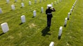 Honoring the Fallen: A Marine\'s Tribute at National Military Cemetery Royalty Free Stock Photo