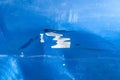 Hood of the blue car with scratched and damaged paint peeled from the crash accident close up Royalty Free Stock Photo