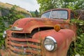 The hood is cracked open on a 1948 Chevy Truck in a junkyard in Idaho, USA - July 26, 2021