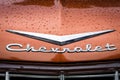 Hood emblem of Chevrolet in raindrops.