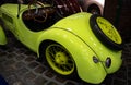 The hood of a green or yellow retro car. Lacquered, shiny antique vintage car. Close up Royalty Free Stock Photo