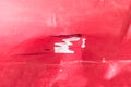 Hood of the red car with scratched and damaged paint peeled crack from the crash accident close up Royalty Free Stock Photo