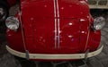 The hood of a red retro car. Lacquered, shiny antique vintage car. Close up