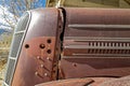 Hood vents on the side of a rusty antique car resting in the desert in Nevada, USA Royalty Free Stock Photo