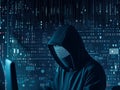 Hooded computer hacker in the shadow with binary codes