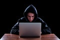 Hooded computer hacker stealing information Royalty Free Stock Photo