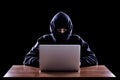 Hooded computer hacker stealing information Royalty Free Stock Photo