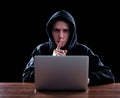 Hooded computer hacker stealing information Royalty Free Stock Photo