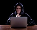 Hooded computer hacker stealing information Royalty Free Stock Photo