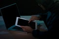 Hooded cyber crime hacker using digital tablet internet hacking