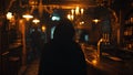 A hooded figure slinks through the dimly lit tavern their movements quiet and purposeful as they make their way to a