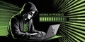 Hacker wearing a hoodie typing on a laptop with binary code and progress bar hacking Royalty Free Stock Photo