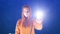 Hooded girl points with her hand in a cyberspace digital environment, ideal for topics such as ecology and online safety
