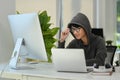 Hooded hacker breaking data servers on computers and infects system with virus Royalty Free Stock Photo