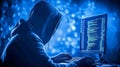 Hooded hacker coding at computer in dark, cybercrime concept