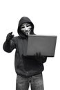 Hooded hacker with mask holding laptop while appoint