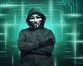 Hooded hacker with mask standing Royalty Free Stock Photo