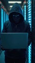 Hooded hacker stealing data from a secure server room
