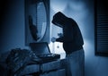 Hooded home burglar taking jewelery