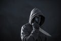 Hooded man with black mask holding knife Royalty Free Stock Photo