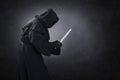 Hooded man with dagger in the dark Royalty Free Stock Photo