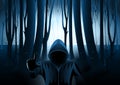 Hooded man in Dark mysterious forest Royalty Free Stock Photo