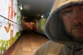 Hooded man in graffiti decorated subway