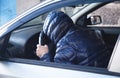 Hooded Man holding steering wheel. Driving car Royalty Free Stock Photo