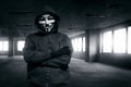 Hooded man with mask standing alone