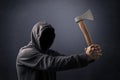 Hooded man with an axe in the dark Royalty Free Stock Photo