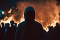 Hooded man. Protests. People silhouettes. Street violence. Street on fire