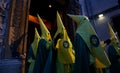 Hooded penitents leaving the church before the start of an easter holy week procession in mallorca