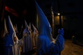 Hooded penitents leaving the church before the start of an easter holy week procession in mallorca