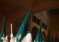 Hooded penitents leaving the church before the start of an easter holy week procession in mallorca