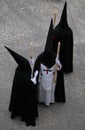 Hooded penitents wait for the start of their Easter holy week in mallorca