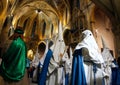 Hooded penitents entering church before the start of an easter holy week procession in mallorca