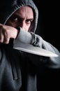 Hooded robber wielding a knife Royalty Free Stock Photo