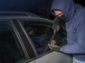 Hooded thief looking to break into a car Royalty Free Stock Photo
