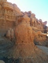 Hoodoo rock formation in front of hills with various layers and textures